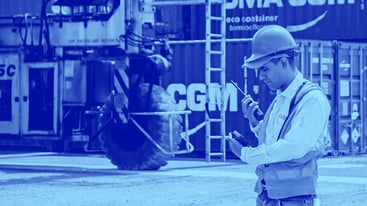 Master Terminal Mobile Apps duotone image of a man talking into a portable radio while on a terminal.