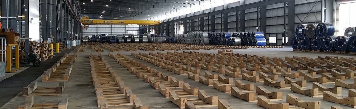 inside the Alabama Steel Terminal port warehouse with bases to hold steel coil rolls